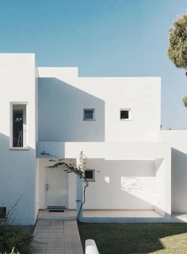 image of a white home with blue skies